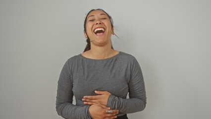 Poster - A joyful hispanic woman laughing heartily against an isolated white background, exuding happiness and positivity.