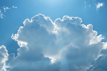 Sticker - Radiant sunbeams peep through the edges of towering cumulus clouds in a clear blue sky