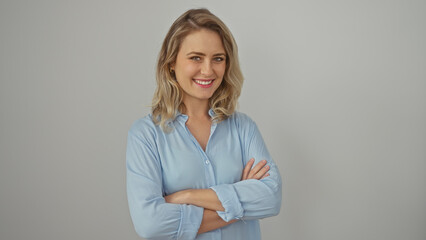 Sticker - Confident young blonde woman in casual clothing, posing with arms crossed against a clean white background.