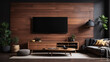 © Rania - A dark wood TV stand with a flatscreen TV on it. There is a lamp and plants on the left side of the TV and a plant on the right side.