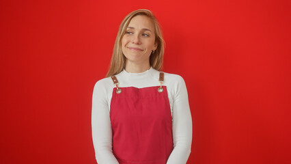 Sticker - Smiling blonde woman in white top and red overalls against a solid red background