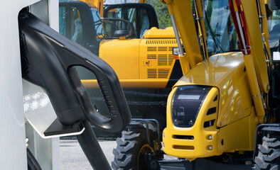 Poster - Electric construction machines with charging station. Concept