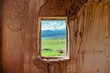 Window of old rural ruined house with view on mountain valley in summer