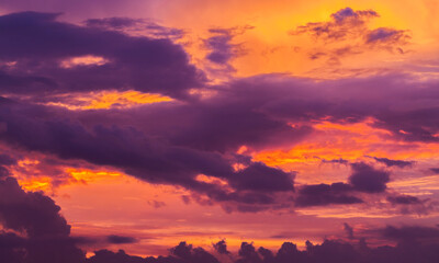 Wall Mural - dramatic sunset sky with deep purple clouds, natural photo