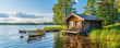 Serene Lakeside Retreat: Rustic Wooden Cabin and Rowboat at Tranquil Finnish Lake