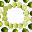 Green lime fruits on white, copy space. Top view flat lay