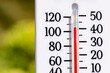 Outdoor thermometer in the sun during heatwave. Hot weather, high temperature and heat warning concept.