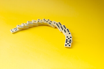 Wall Mural - Dominoes with yellow background, copy space and various angles