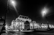 The historic building of the National Theatre in Prague and traffic on the busy street. Public Transportation Night Lights Tram Motion, light trails. Long Exposure . Black and white photo concept.
