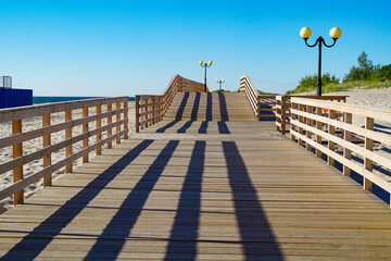 A wooden path on the beach on a sunny day