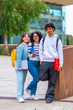 © unai - Portrait of multiracial university exchange students standing in the campus