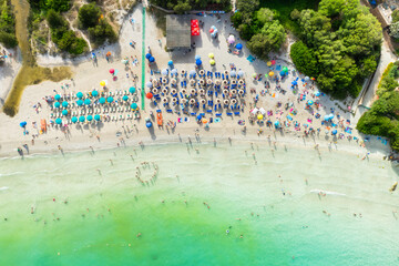 Wall Mural - aerial view on beach, people and umbrellas. vacation and adventure. europe, mediterranean sea. top v