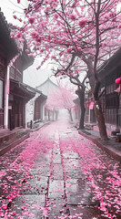 Wall Mural - A street in an old town of China, with cherry blossom trees on both sides and pink petals scattered all over the ground. The picture is a real photo taken by Sony cameras. In spring, it was foggy and 