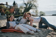 © qunica.com - A joyful scene of three friends lounging on a beach, sharing laughs and stories under the sun. The perfect depiction of beach day happiness and relaxation.