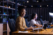 © Wavebreak Media - Diverse female colleagues in headsets at office, working late, focused on screens