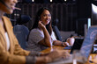 © Wavebreak Media - At office, diverse female business colleagues wearing headsets, working late