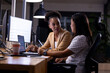 © Wavebreak Media - Diverse female colleagues discuss work late at office, using computers