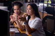 © Wavebreak Media - Diverse female colleagues discussing at computer, working late