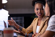 © Wavebreak Media - At office, diverse female business colleagues discussing work, working late