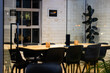 © Wavebreak Media - At office, working late, black chairs surrounding wooden table