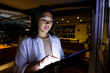 © Wavebreak Media - At office, biracial businesswoman reviewing data on tablet, working late