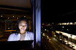 © Wavebreak Media - At office, biracial businesswoman examining tablet by window, working late, copy space