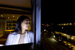 © Wavebreak Media - At office, biracial businesswoman studying tablet near a window at night, copy space