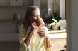 © Wavebreak Media - At home, mature Caucasian woman enjoying coffee, standing by window