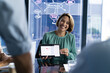 © Wavebreak Media - A diverse team at office discussing business papers, one holding tablet