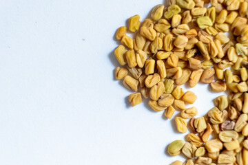 fenugreek seeds isolated on the white background, top view.