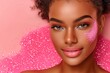 Beautiful african american woman with pink face powder on pink background