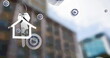 Image of bar graph icons and hanging silver house keys against blurred view of tall building