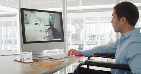 Canvas Print - Image of biracial colleague wearing blue shirt, focusing on computer screen