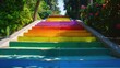 © Artyom - Colorful painted outdoor stairs representing pride rainbow under sunlight amid green trees
