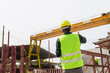 © JU.STOCKER - Back view of Engineer man checking project at construction site, Factory foreman worker in hardhat at the precast factory site