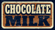 Aged and worn retro chocolate milk sign on wood
