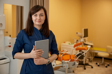 woman doctor gynecologist with clipboard in her clinic office