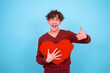 Valentine's Day Funny guy posing in the studio. Blue background.