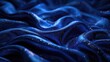 Elegant sapphire blue velvet fabric with light reflecting sparkles and luxurious folds
