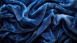 Deep blue velvet fabric with a glossy texture and subtle sparkling highlights
