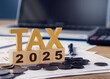 Tax wooden letter and 2025 number on wooden block. Income tax return.Tax, investment, financial, savings and New Year Resolution concepts. Pay tax in 2025 years.