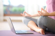 Close up of a woman watching yoga tutorial on laptop