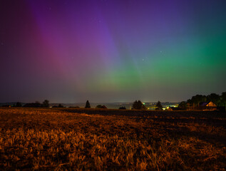 Wall Mural - aurora over the field in the night in germany
