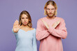 © ViDi Studio - Young strict couple two friends family man woman wear pink blue casual clothes together holding folded crossed hands in stop gesture isolated on pastel plain light purple background studio portrait.