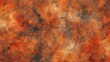 Close-up view of a dry, cracked desert surface with deep orange hues

