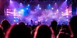 © Anastasiia - Crowded outdoor music festival stage at dusk with shallow focus on audience. Concept Music Festival, Outdoor Stage, Crowd, Dusk Lighting, Shallow Focus