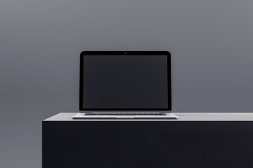 Poster - Elegant laptop on a black podium featuring a dark screen, suitable for high-end tech displays and presentations. 3D Render