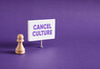 Chess pawn standing next to the banner with the word Cancel Culture.