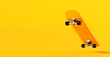 Yellow skateboard levitating on yellow background with copy space.