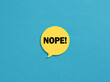 The word Nope on yellow speech bubble over blue background.